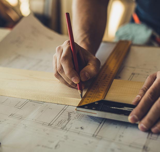 Construction worker making measurements for home improvement project.