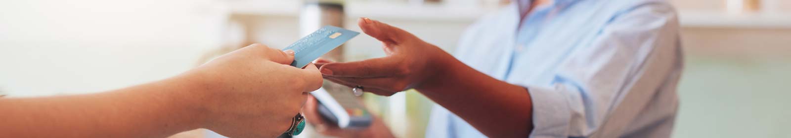 Person handing their debit card for payment.