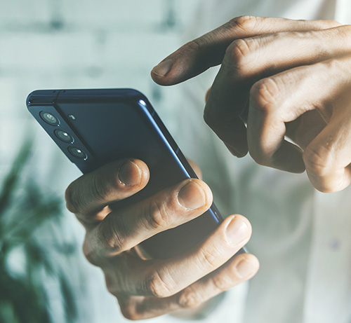 Person tapping on their phone.