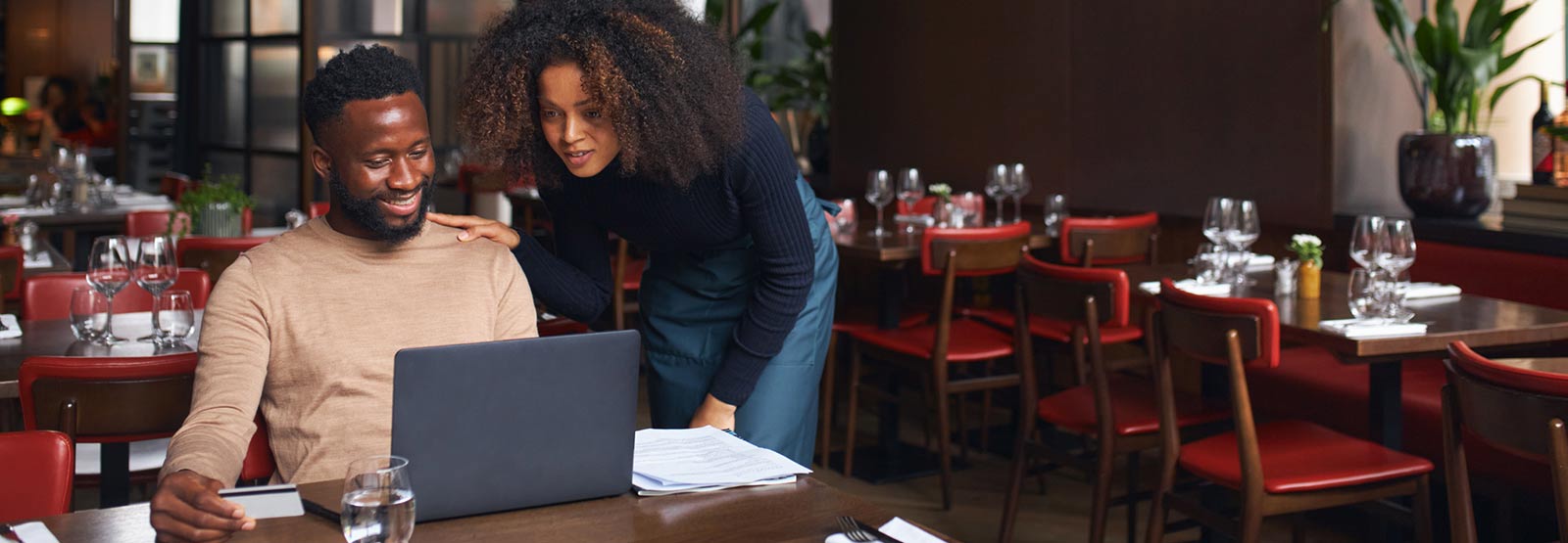 Business couple reviewing financials on a laptop.