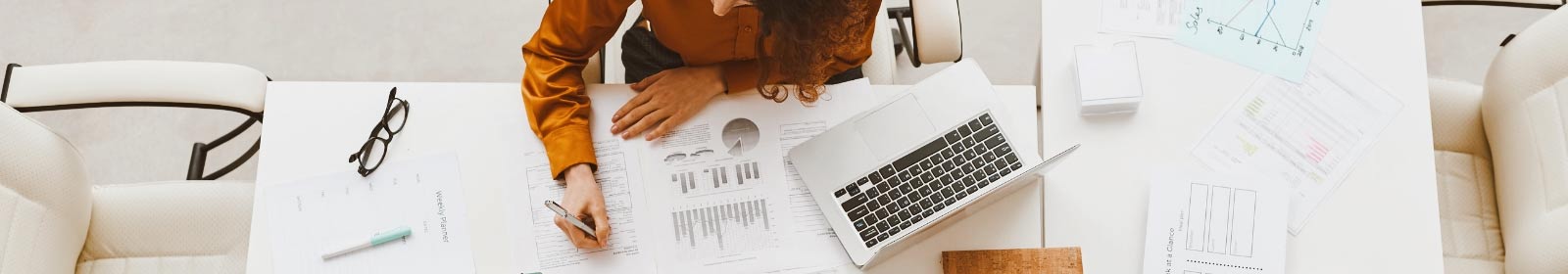 Person at their desk working on financials.