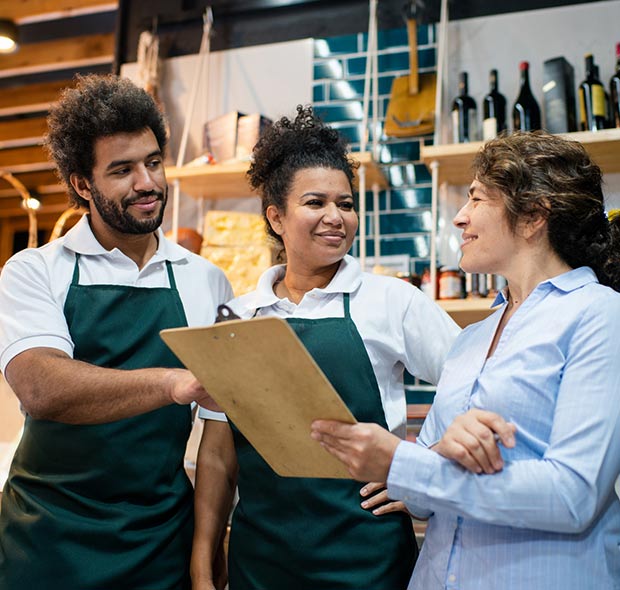 Business owner speaking with employees.