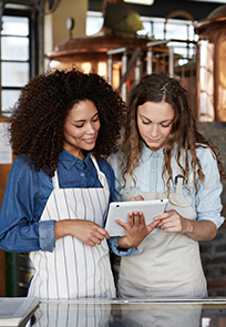 Small business owners looking at a Tablet.